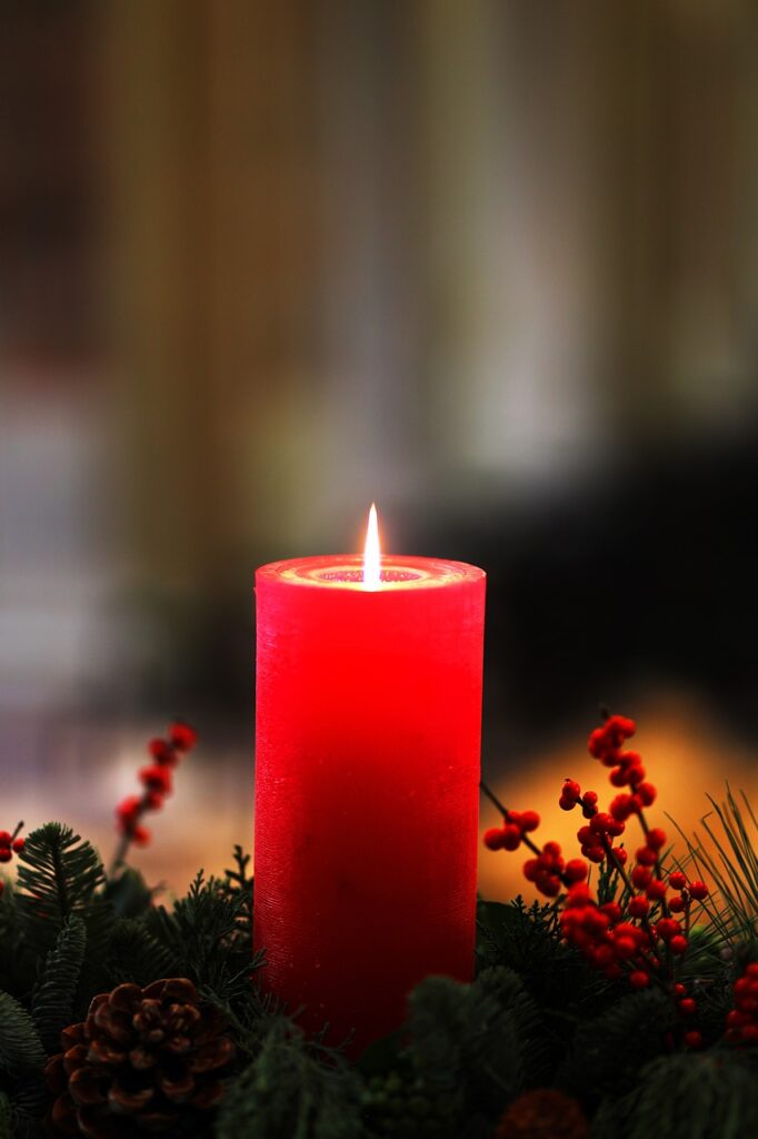 Photo of the christmas collection "cinnamon candle". Picture of red candle on a pine tree.